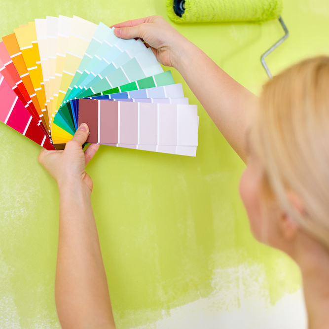 Woman choosing paint color from color chips