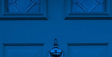 Photo of front door with lights and brass knocker