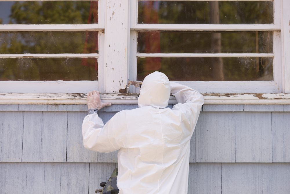 worker removing lead paint